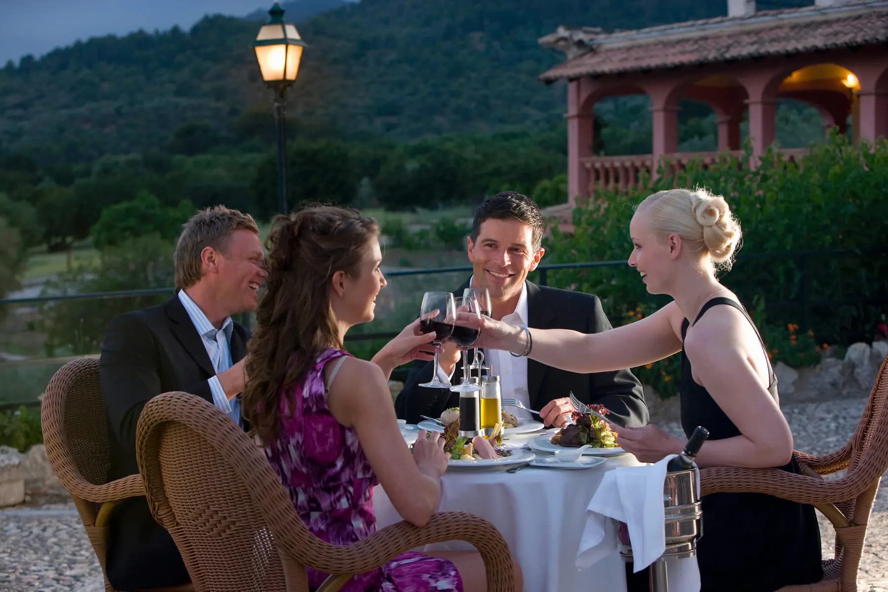 Elegant outdoor dinner on a Riviera terrace at dusk